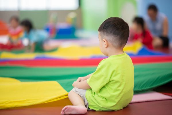 Little toddler boy working out at the indoor gym excercise