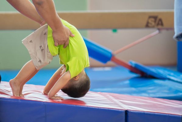 Little toddler boy working out at the indoor gym excercise